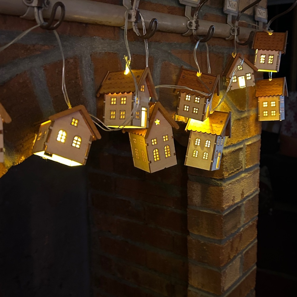 2 sets of tiny House garland with battery operated lights inside. 10 ft cord.